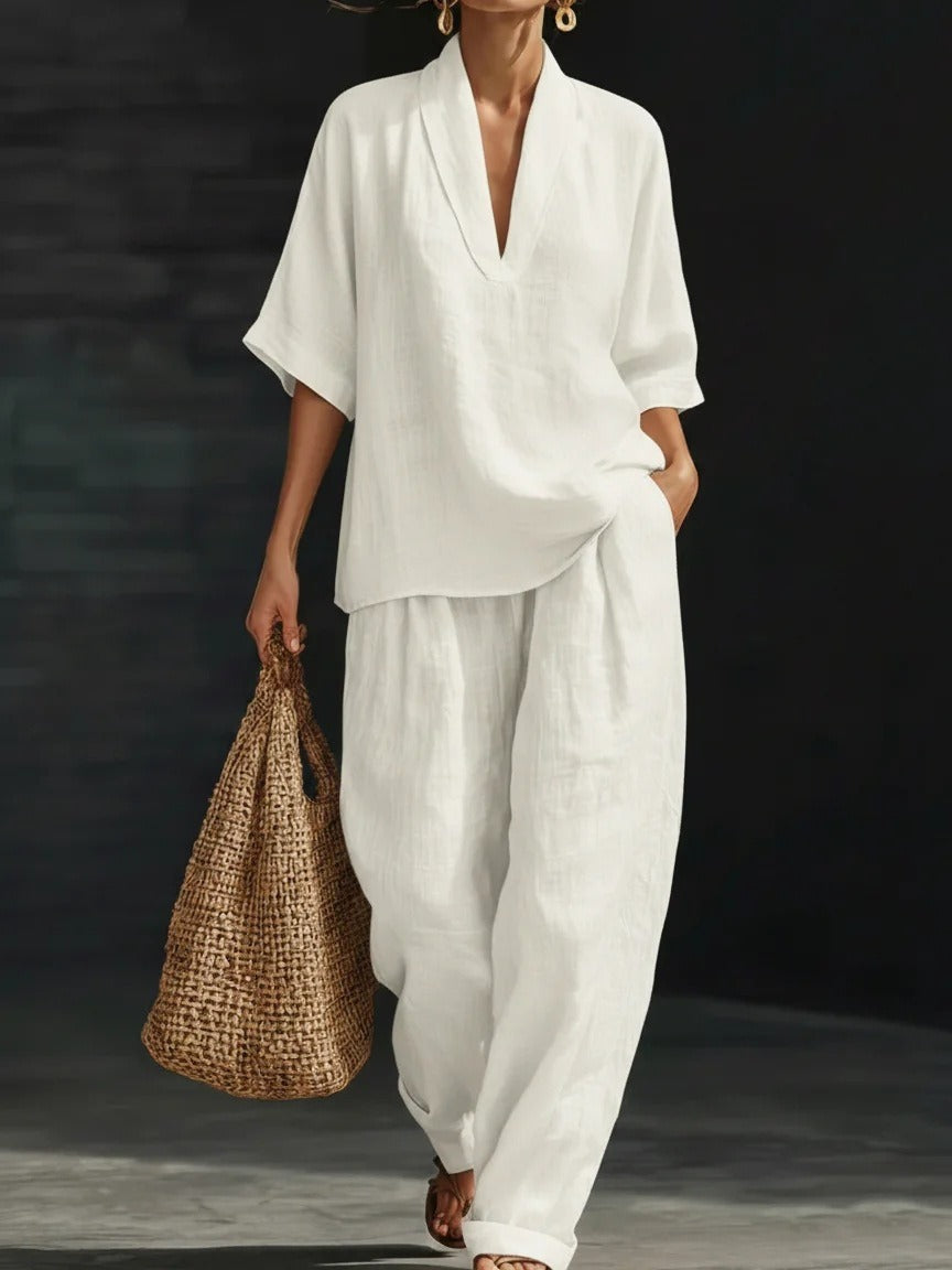 Conjunto casual blanco de dos piezas para mujer con blusa de manga corta y pantalón holgado de poliéster suave.
