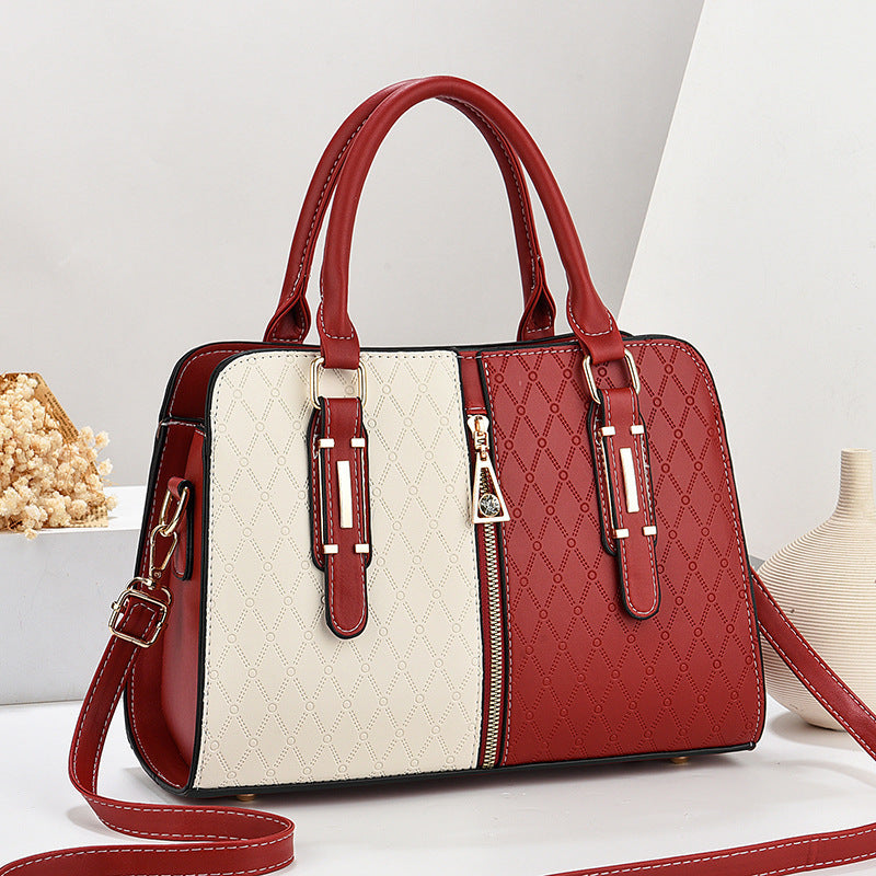 Bolso tote grande para mujer en color-block rojo y beige con textura geométrica, cremallera frontal y doble asa.